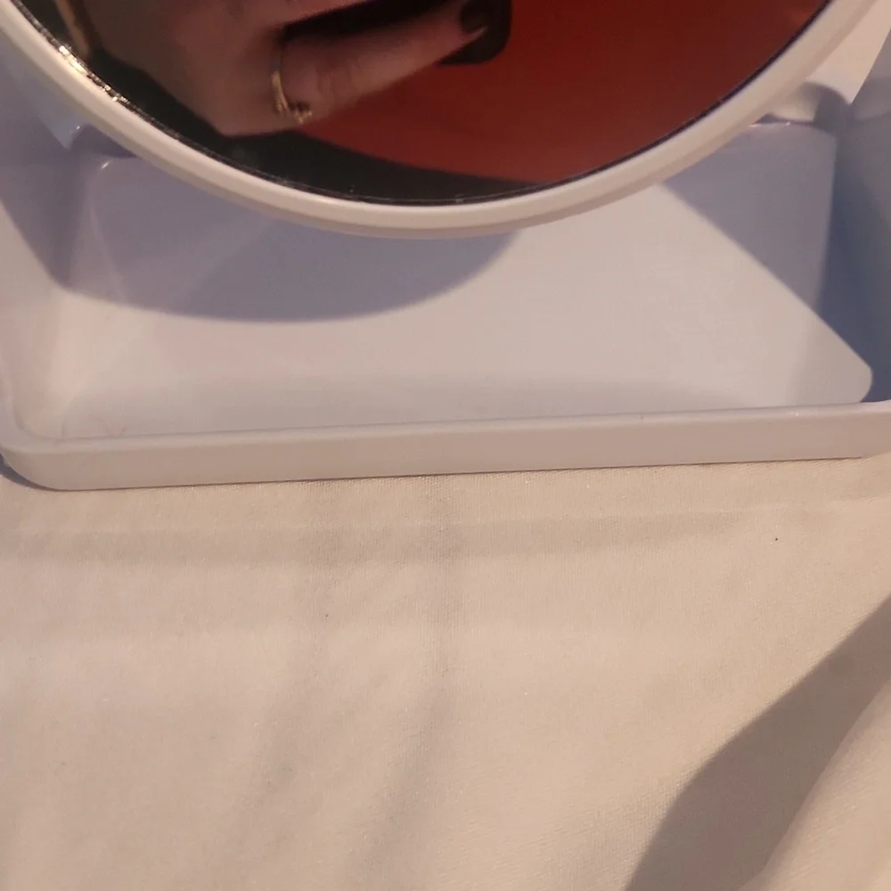 White double-sided vanity mirror with one side magnified.